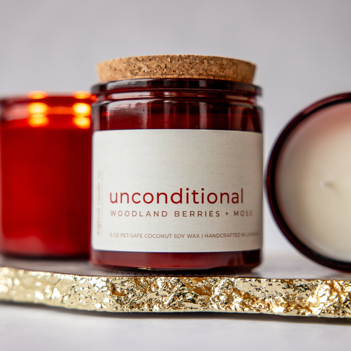 Valentine's day Candle with a 'unconditional' label on a decorative surface