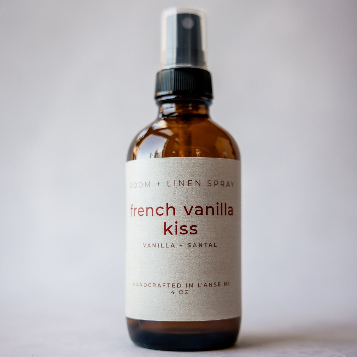 Bottle of 'French Vanilla Kiss' room and linen air freshener spray on a light gray background