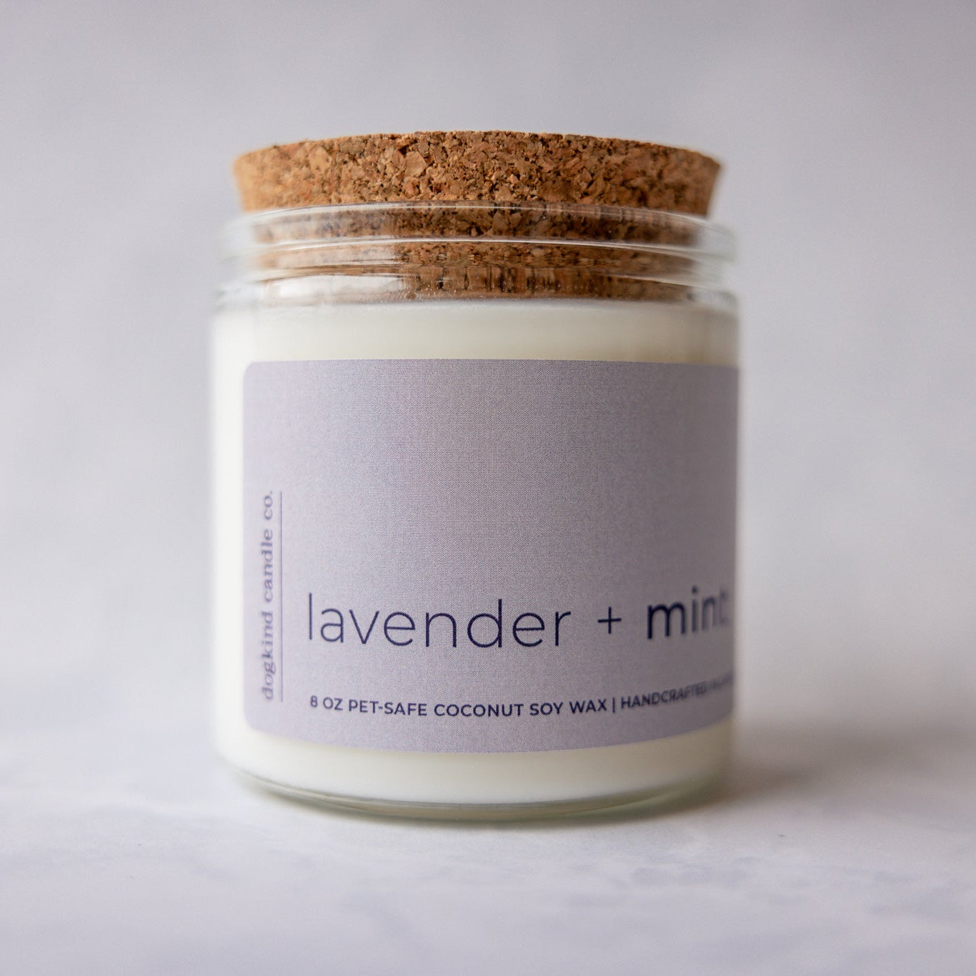 
                  
                    Candle jar with cork lid and lavender and mint label on a light background
                  
                