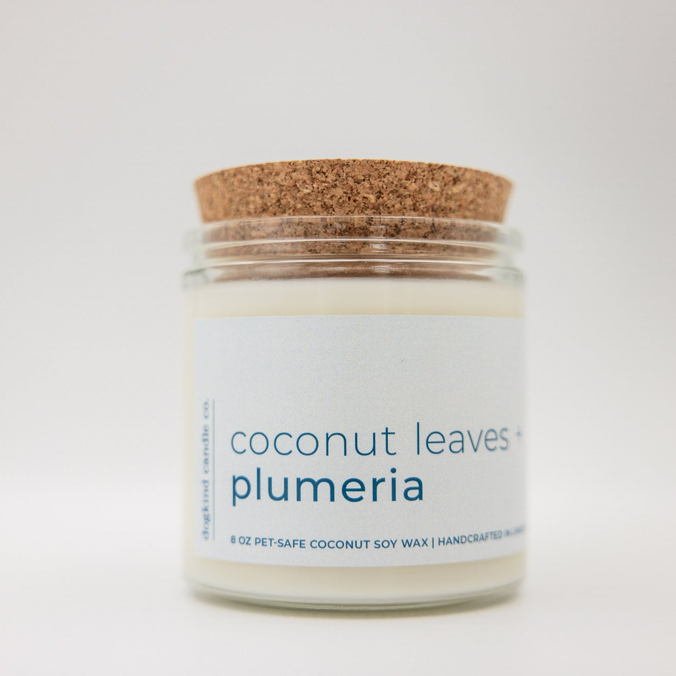 
                  
                    Candle jar labeled 'coconut leaves plumeria' with a cork lid on a white background
                  
                
