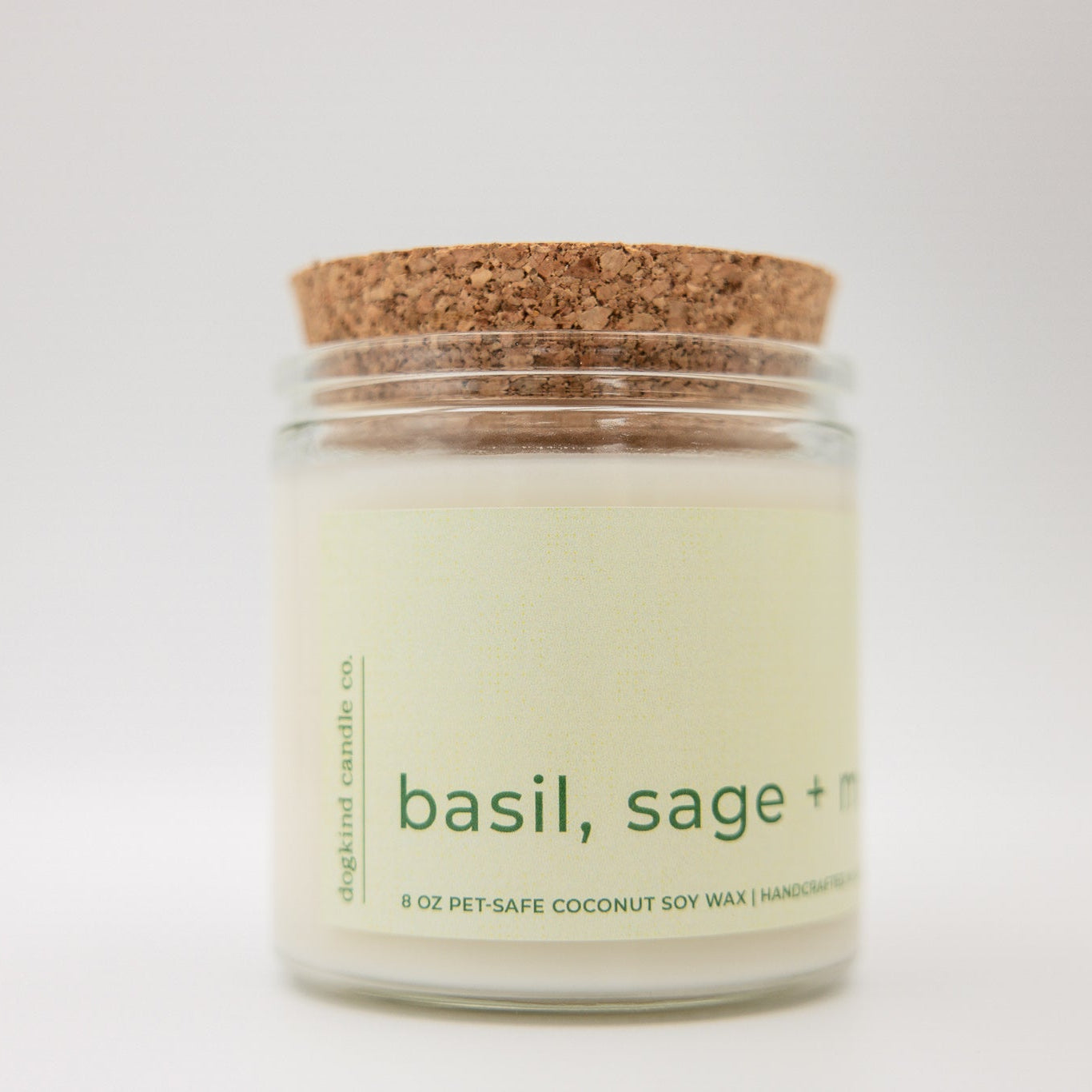 
                  
                    Candle jar with cork lid labeled 'basil, sage +' on a white background
                  
                