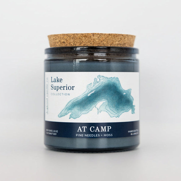 Candle jar with cork lid and 'Lake Superior' label on a white background