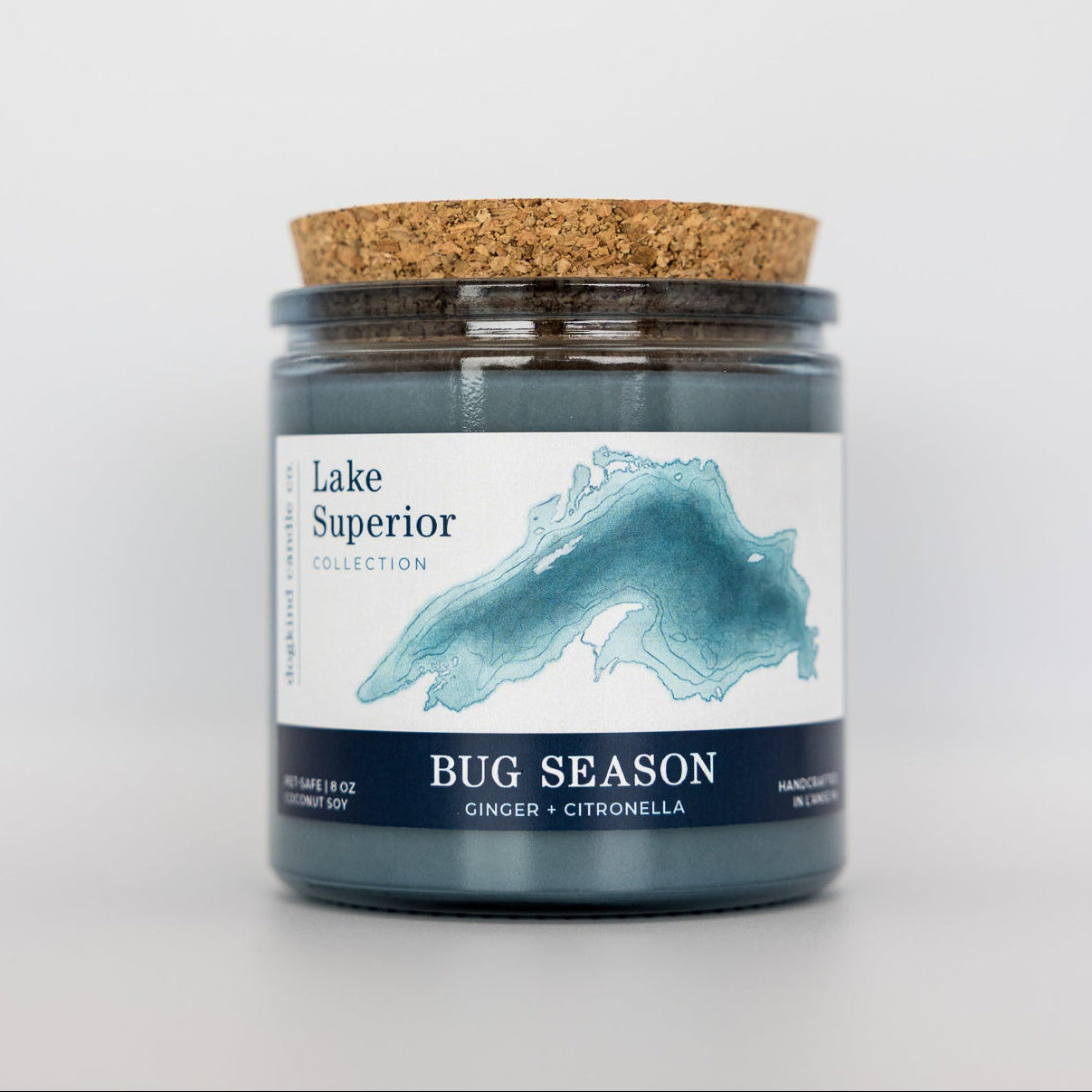 Candle jar labeled 'Lake Superior Collection Bug Season' on a white background