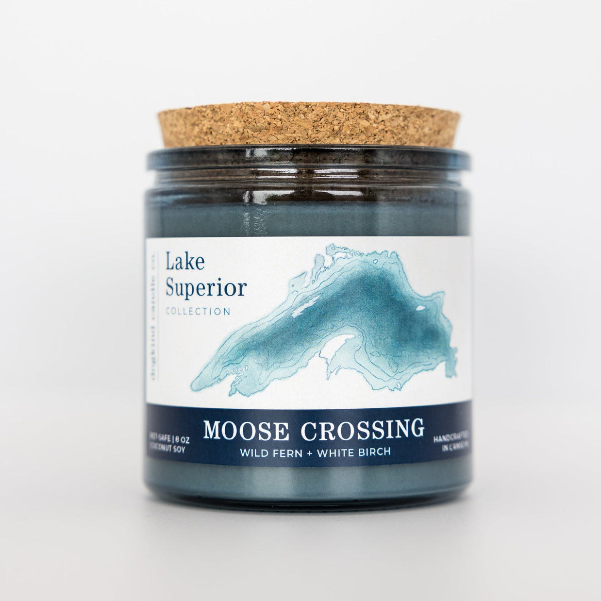Candle jar with cork lid and 'Lake Superior Collection' label on a white background