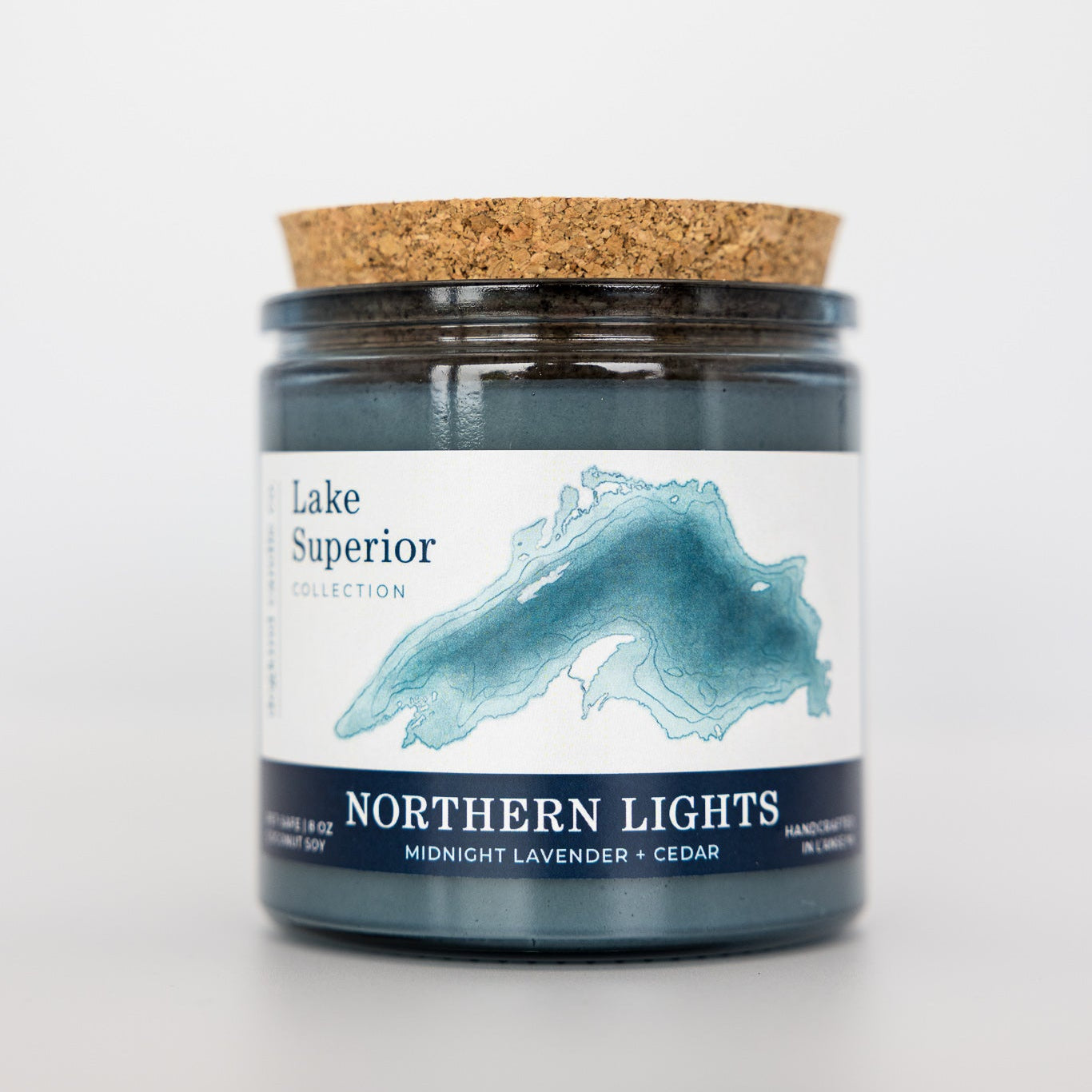Candle jar with cork lid and 'Lake Superior Collection' label on a white background