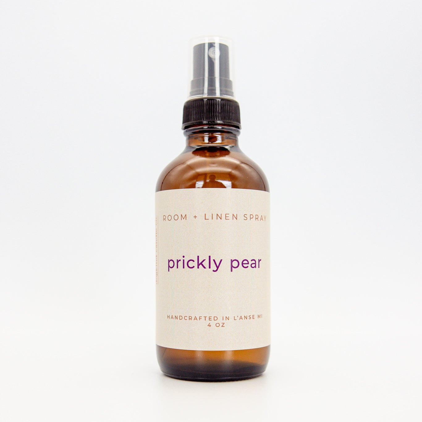 Bottle of 'prickly pear' linen spray on a white background