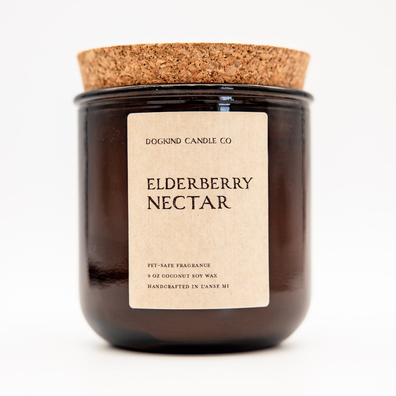 
                  
                    A dark amber glass jar candle with a natural cork lid and a cream paper label reading 'DOGKIND CANDLE CO. ELDERBERRY NECTAR' on a white background.
                  
                