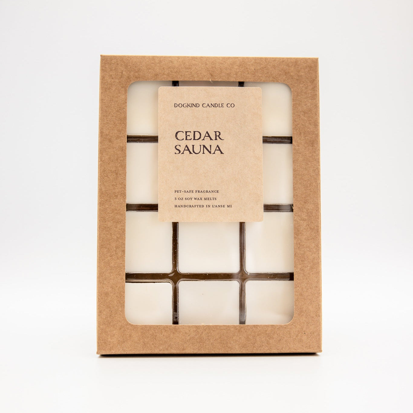 A boxed soy wax melt set labeled 'CEDAR SAUNA' by Dogkind Candle Co, shown in a kraft paper window box on a clean white background.