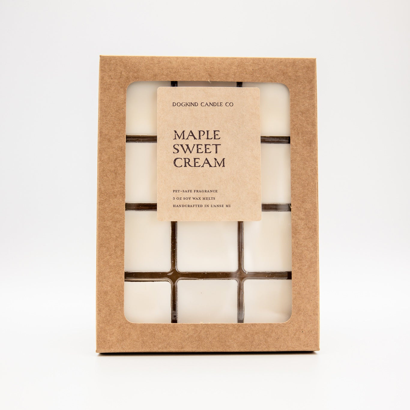 A boxed wax melt set from Dogkind Candle Co. labeled 'CIDER MILL MARKET' in natural kraft paper packaging with a clear window showing multiple square candles inside, photographed on a clean white background.