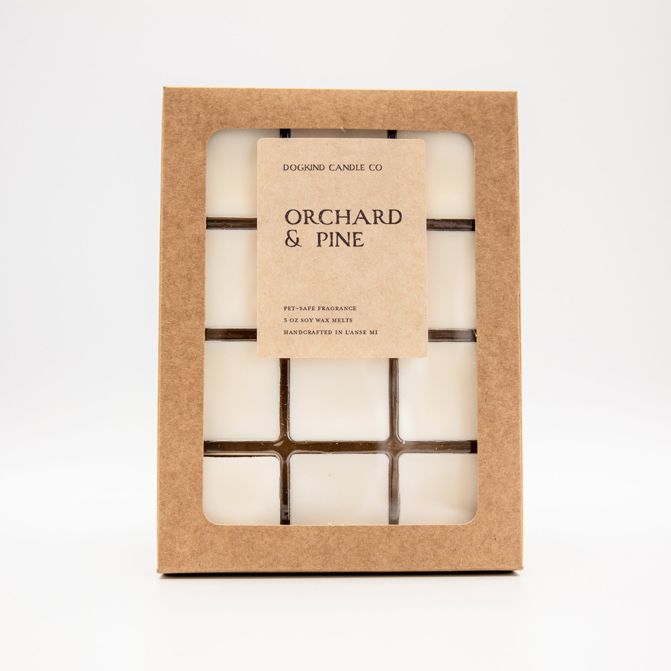 A wax melt set labeled 'Patchouli Pumpkin' by Dogkind Candles Co., shown in a kraft paper window box on a clean white background.